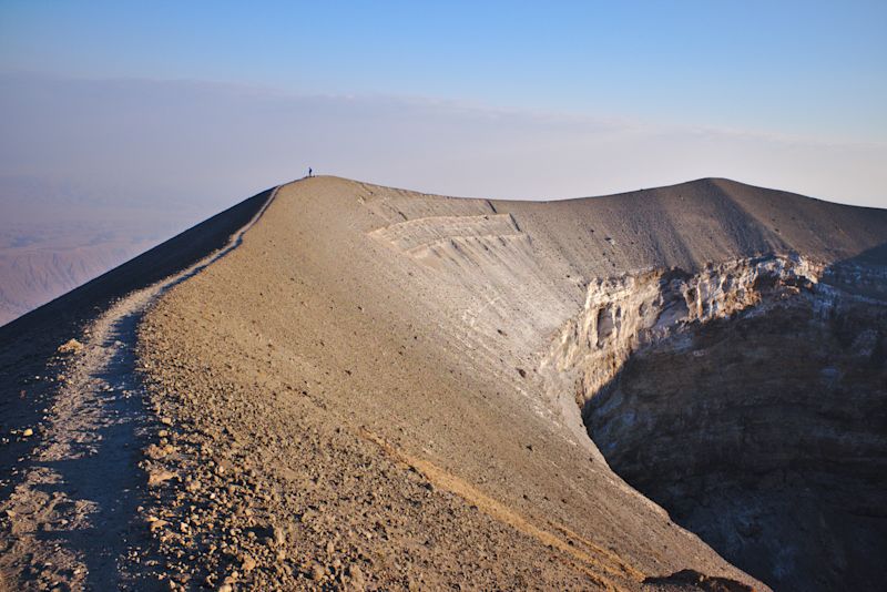 Hiker standing on rim of Ol Doinyo volcano, Tanzania