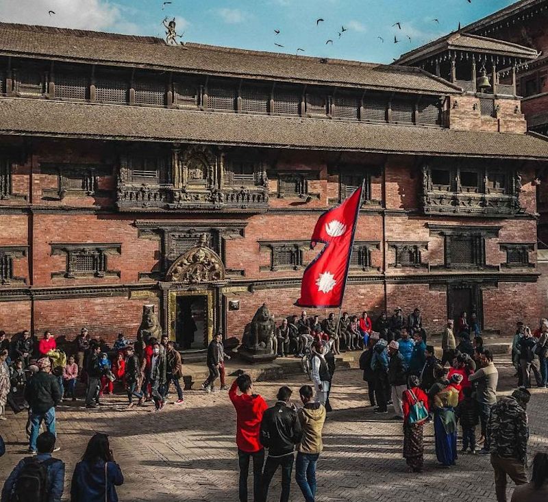 Nepal-flag-in-kathmandu-historic-building-and-crowd