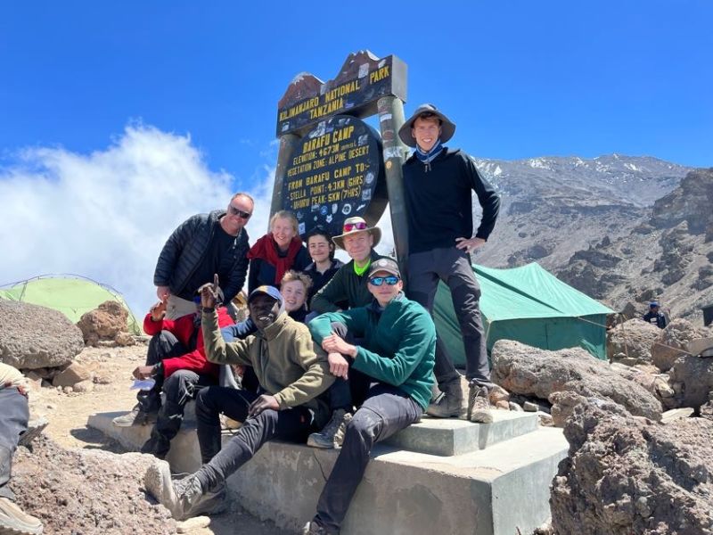 Group pic at Barafu camp sign, Kilimanjaro, in August 2022
