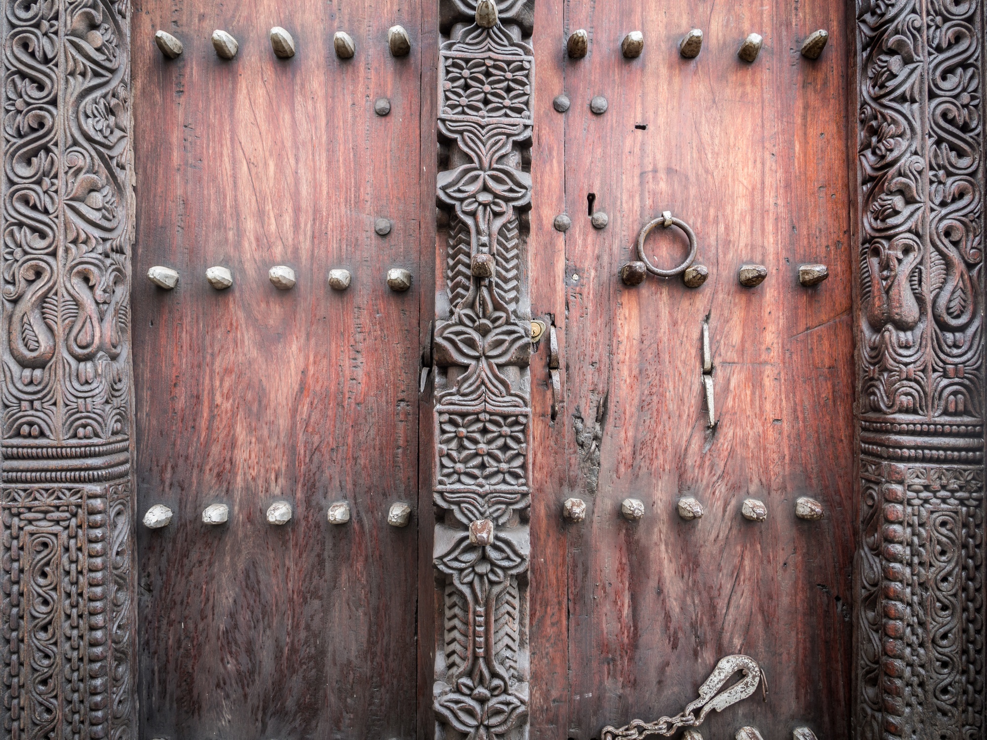 An old traditional wooden carved door in Stone Town, Zanzibar, Tanzania, East Africa, close up.