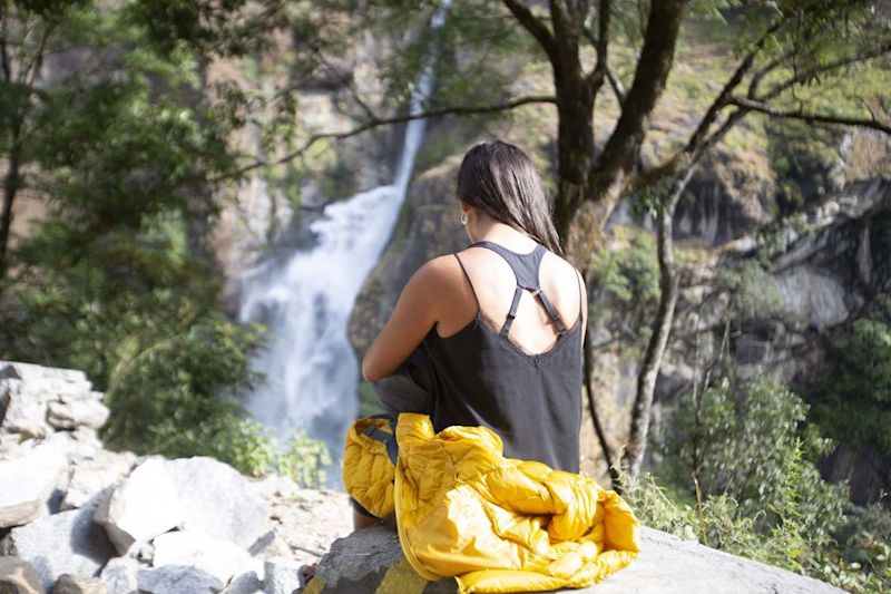 Woman and waterfall along the Annapurna Circuit route in Nepal