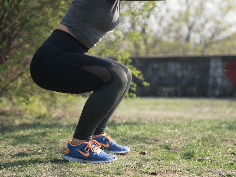 Women doing outdoor squats exercise