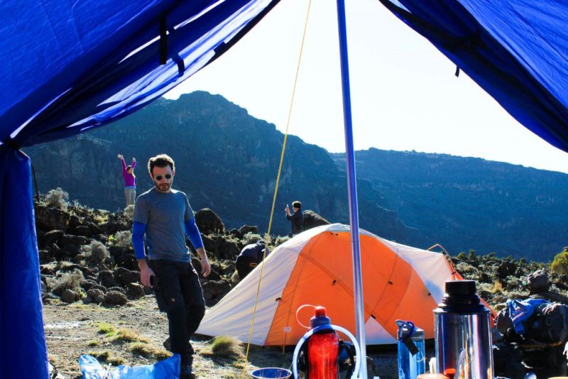 Man outside tent on Kilimanjaro