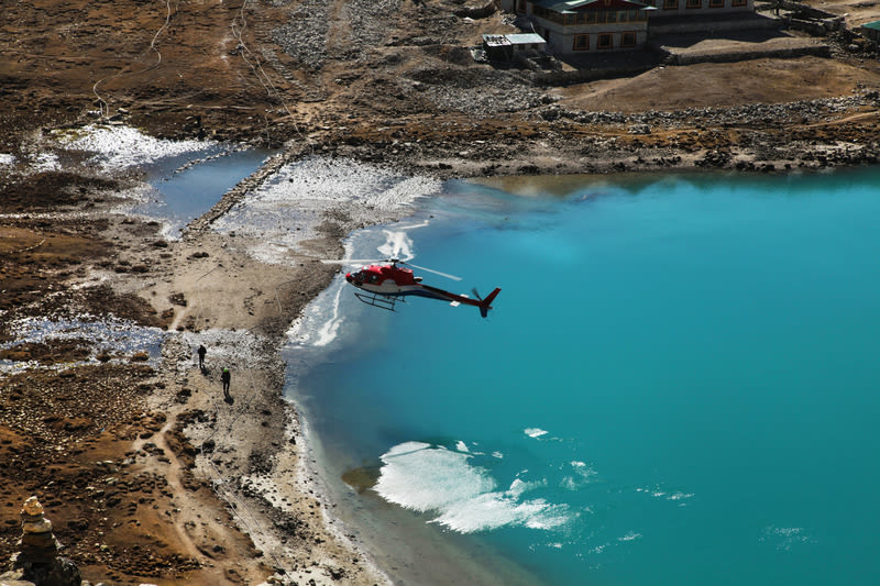 The helicopter over Amazing Gokyo lake in mountains, EBC trek