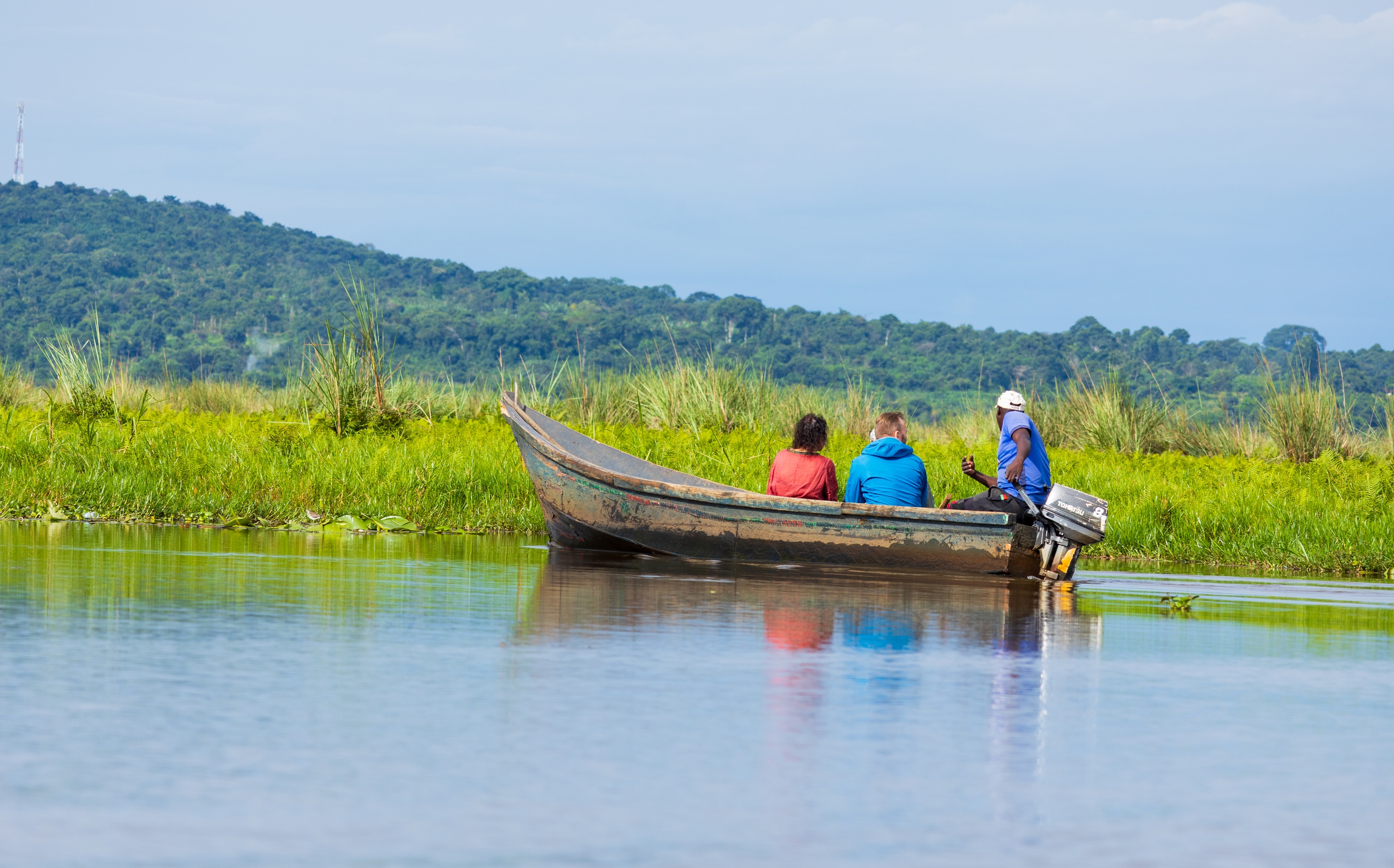  Tourists on a safari by boat, in search of the Shoebill stork and other wildlife on Lake Victoria, Entebbe, Uganda.