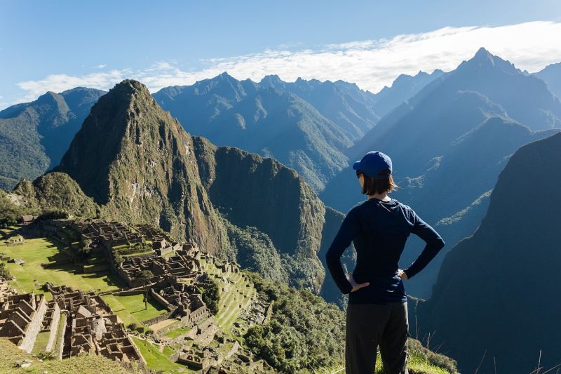 Female trekker overlooking Machu Picchu on Inca Trail, Peru