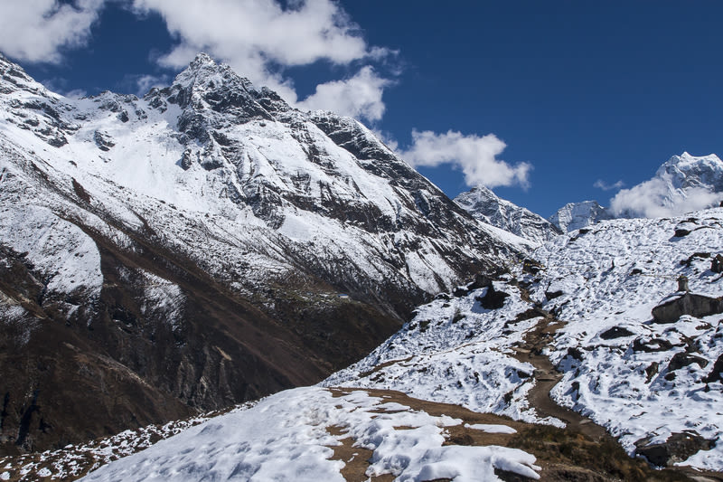 Trek routes through snow leaving village of Machhermo, EBC trek and Gokyo Lakes, Nepal