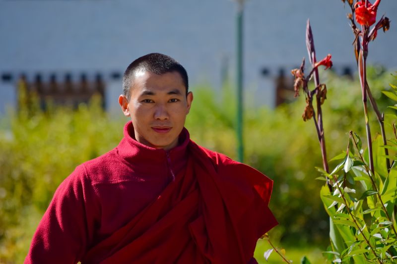 Buddhist monk and canna, Bhutan