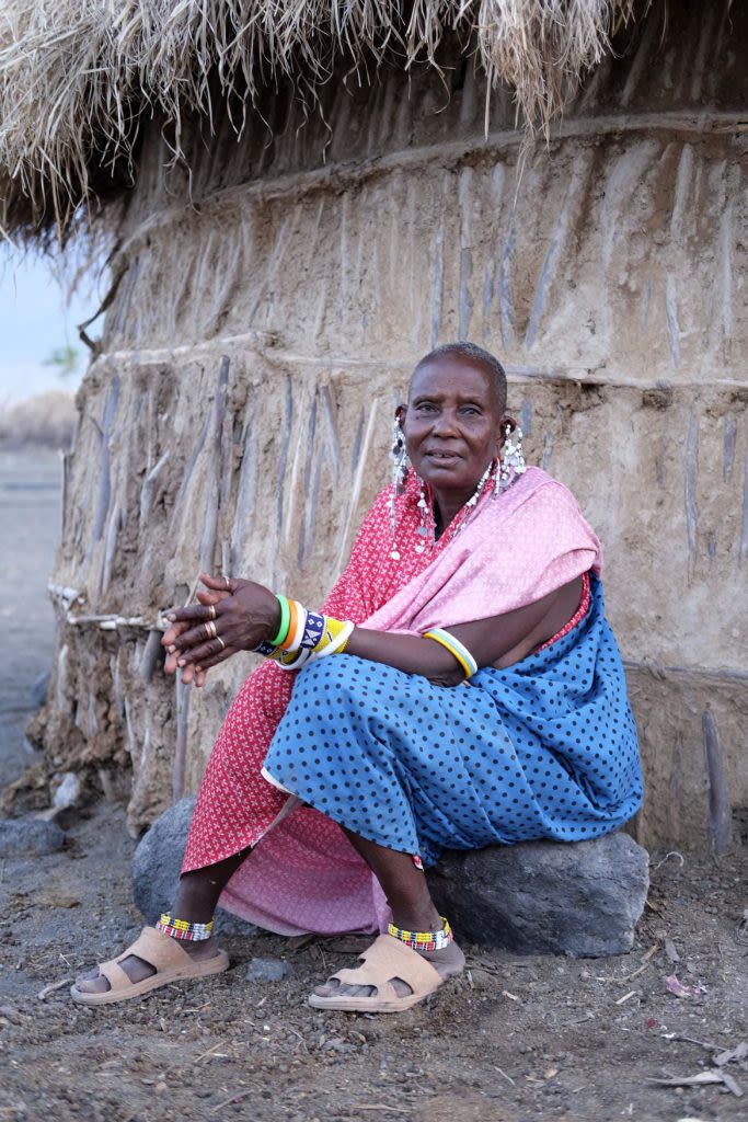 Seated Maasai woman with lots of colourful jewellery