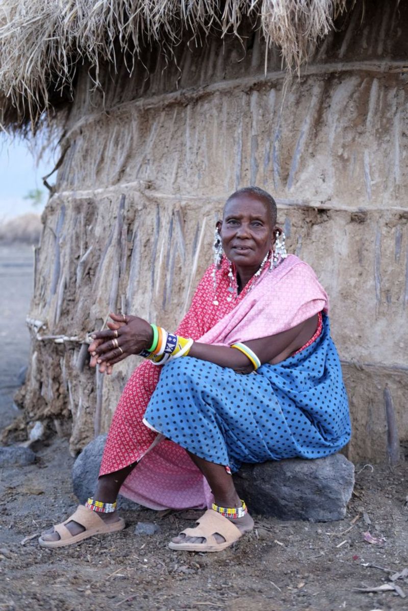 Seated Maasai woman with lots of colourful jewellery