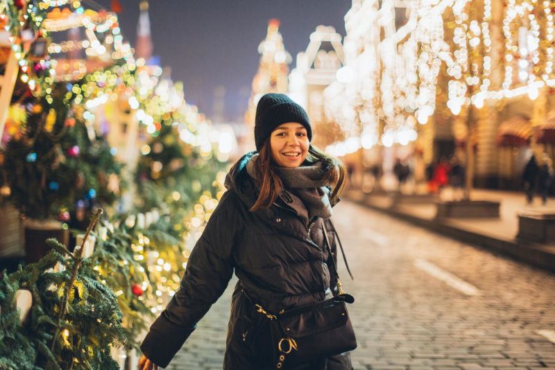 Woman in beanie at a winter outdoors Christmas market 