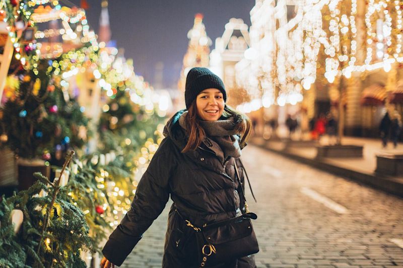 Woman in beanie at a winter outdoors Christmas market