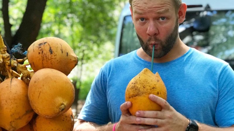 Joel drinking from a coconut in Sri Lanka