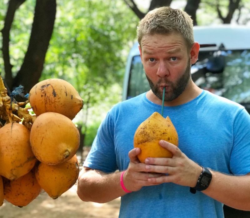 Joel drinking from a coconut in Sri Lanka