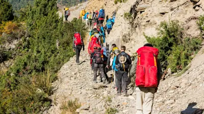 Trekker walking on footpath in the himalayas on the Annapurna Circuit Trek