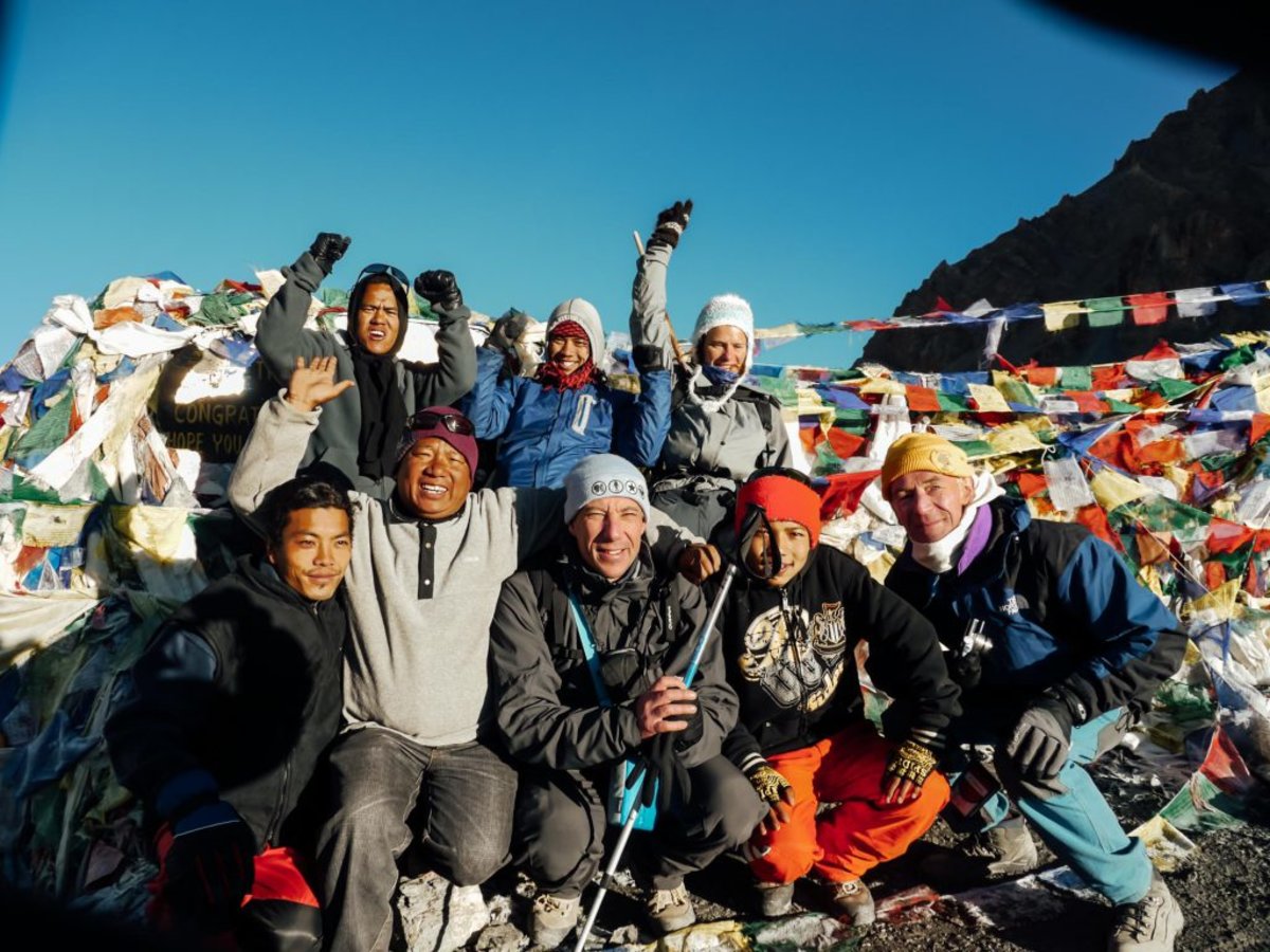 annapurna circuit group celebrating at the top of Thorung La Pass!