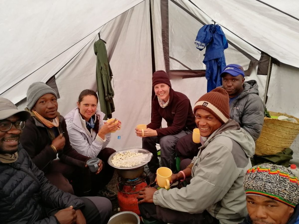 Follow alice mess tent with climbers and crew eating popcorn