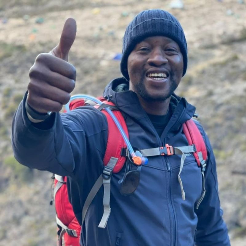 Kabelo thumbs up on Kilimanjaro