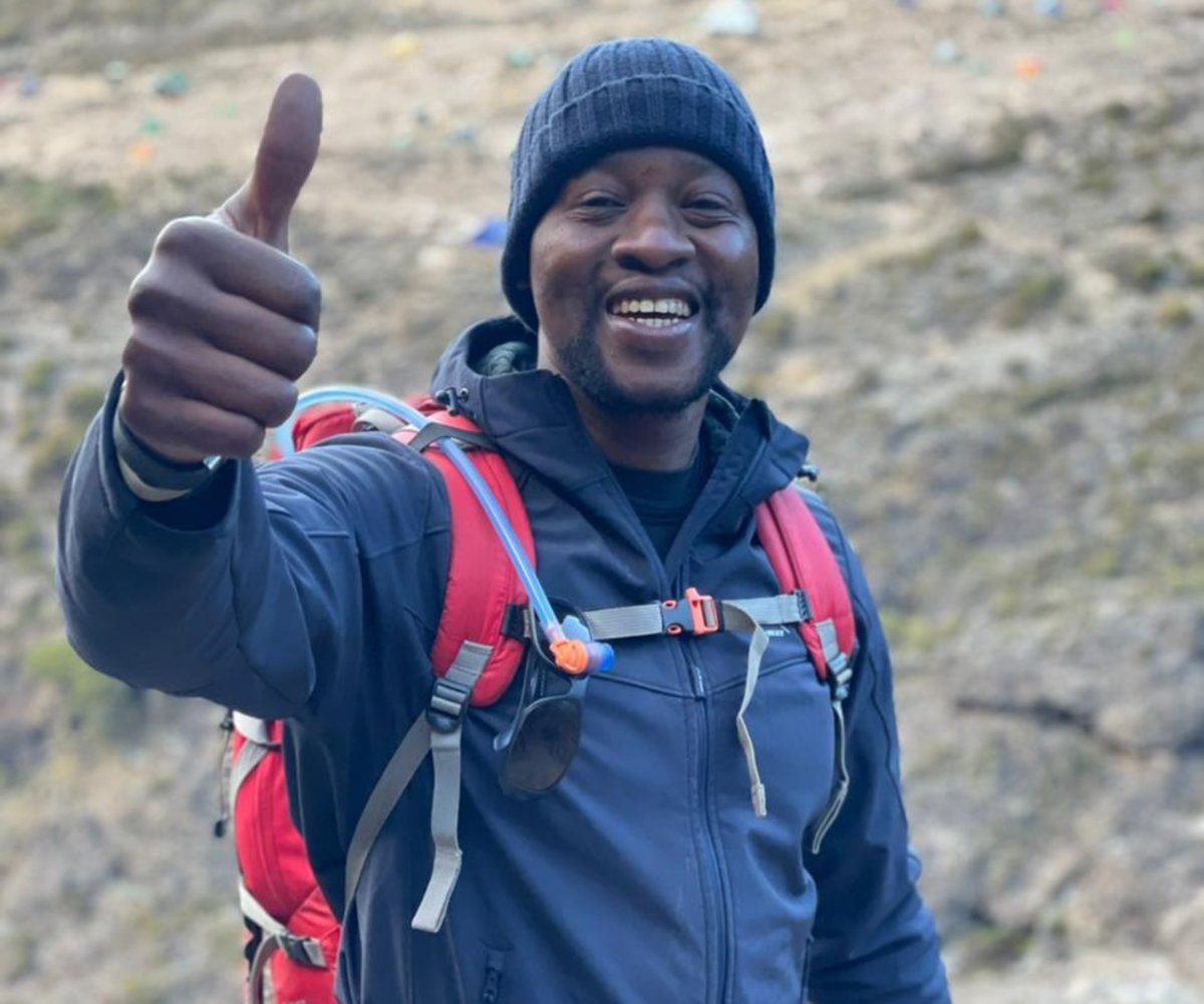 Kabelo thumbs up on Kilimanjaro
