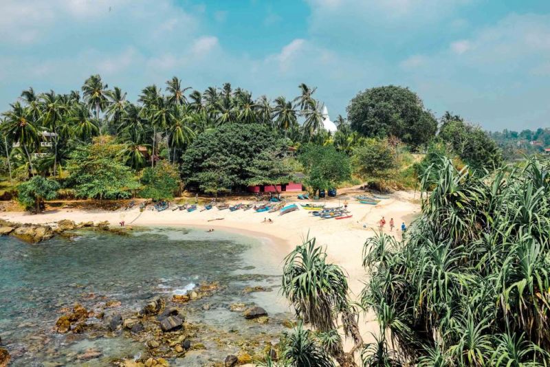 Palm trees, kayaks and white sand beach in Sri Lanka