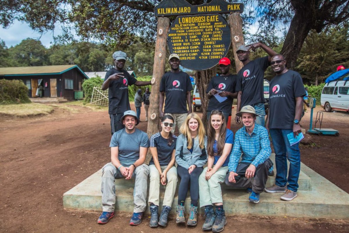 An excited Follow Alice trek group at Londorossi Gate, one of the entryways to Kilimanjaro National Park