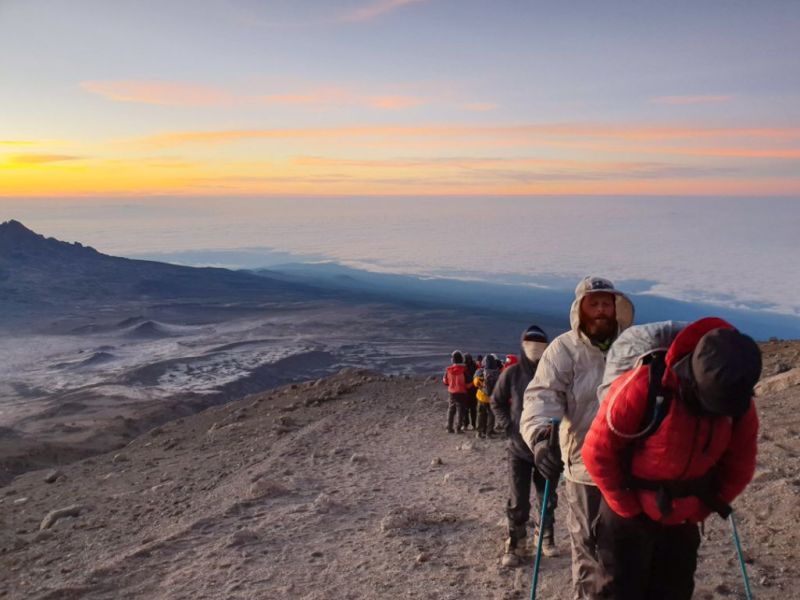 Trekkers hiking above the clouds on Kilimanjaro