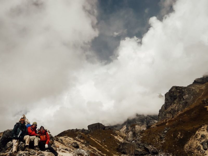 Group photo on mountain with lots of clouds, Everest Base Camp trek cost