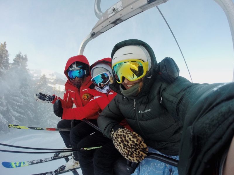 Skiers in chairlift in the Alps