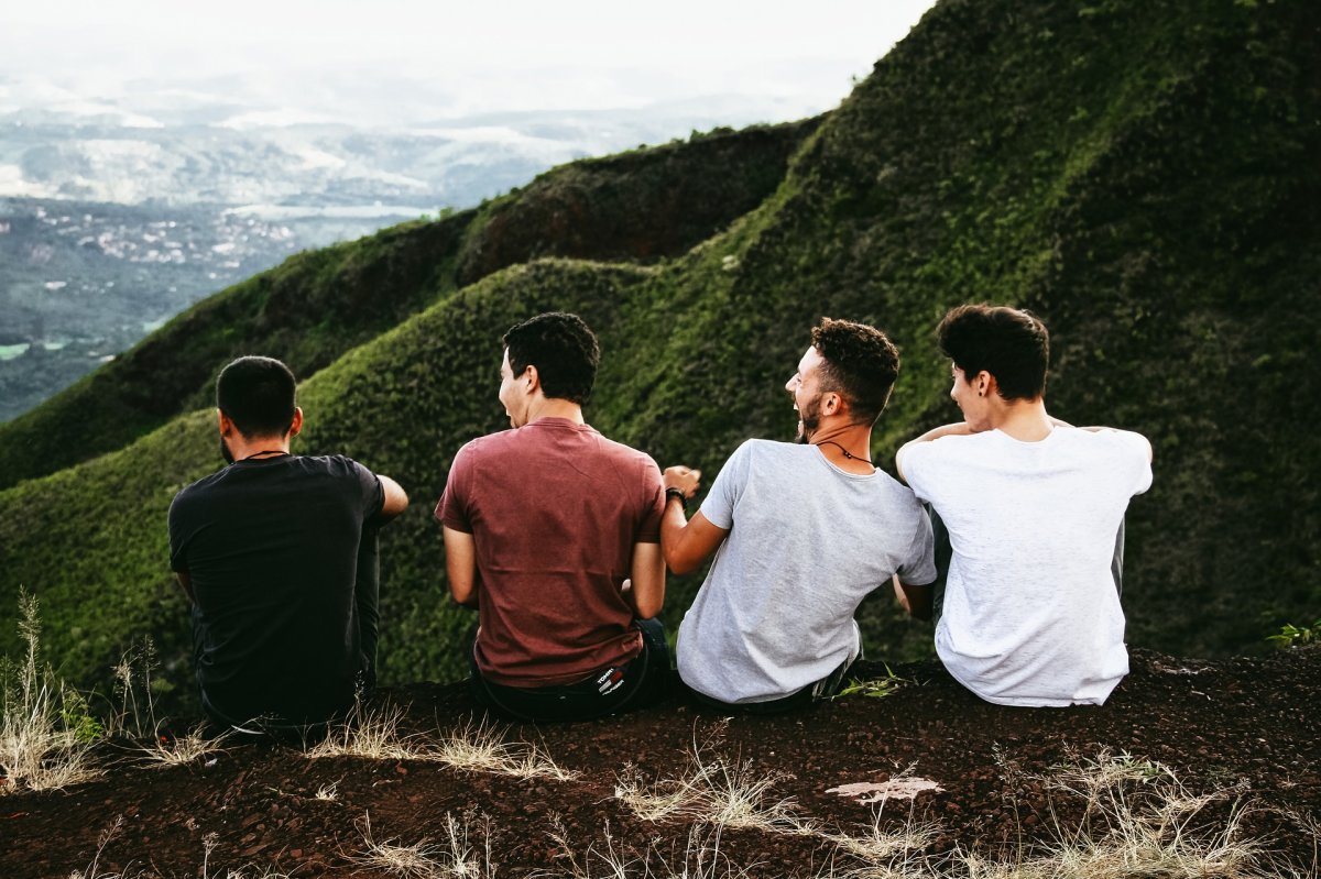 Male friends laughing in nature in mountains