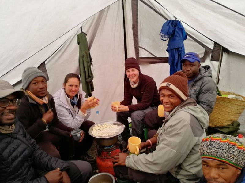 Climbers in the mess tent eating popcorn on Kilimanjaro