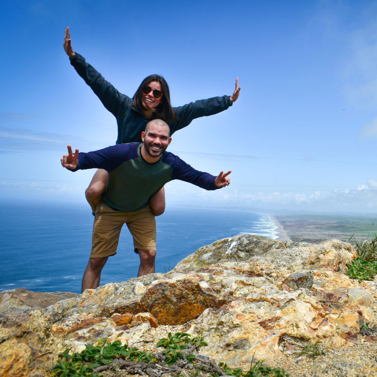Couple hiking above coastline