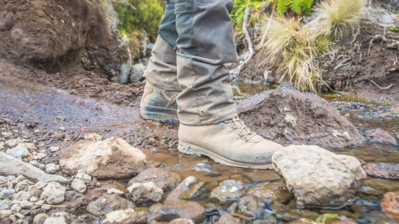 Hiking boots in a stream of water on Kilimanjaro