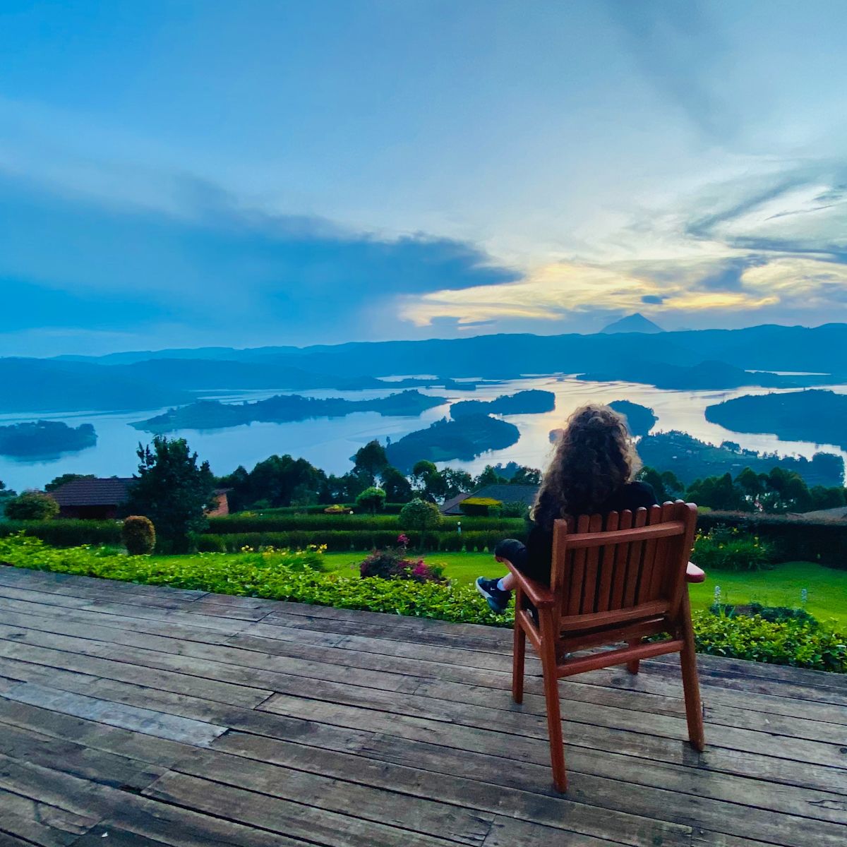 Uganda Lake Bunyonyi woman sitting on deck