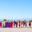Maasai tribe standing in a line on the sand