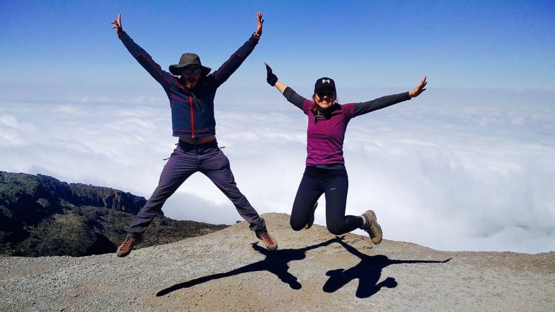 Couple jumping while climbing Kilimanjaro