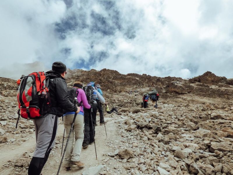 Trekkers with backpacks and trekking poles on the Everest Base Camp Trek, Everest Base Camp packing list