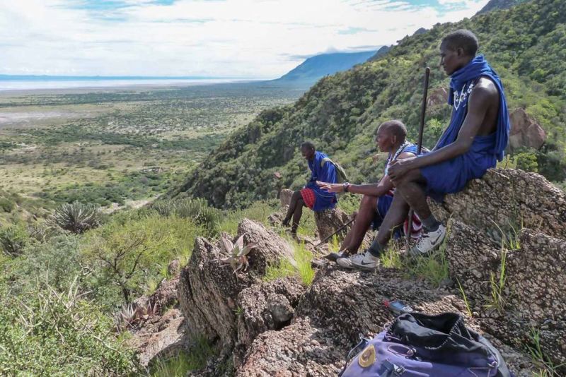 Maasai men sitting on rocks overlooking Lake Eyasi