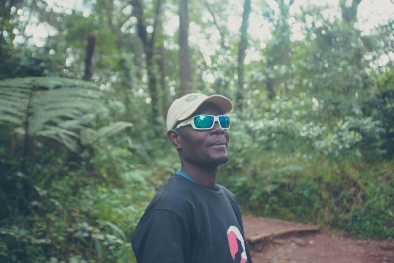 Follow Alice mountain guide with sunglasses on Mount Kilimanjaro