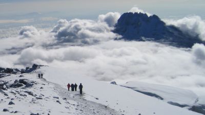 Snow and trekkers on Kilimanjaro summit