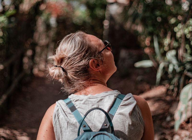 Woman wearing a backpack walking on a hike
