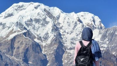 Woman hiker standing looking at mountains in Himalayan range