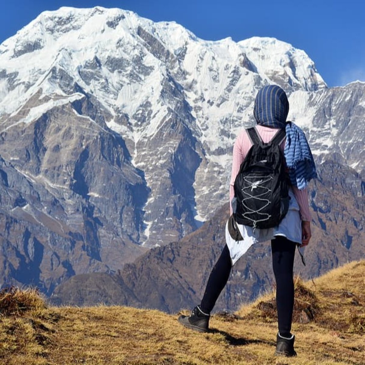 Woman hiker standing looking at mountains in Himalayan range