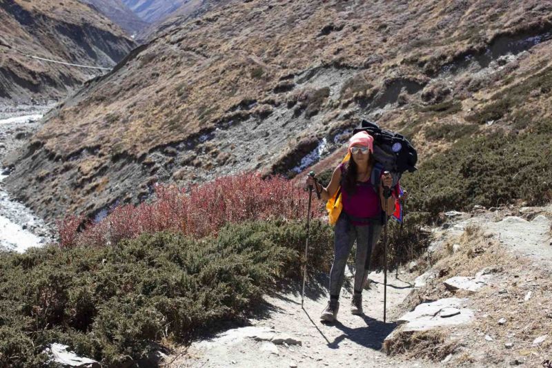 Girl trekking along path of Annapurna Circuit route in Nepal
