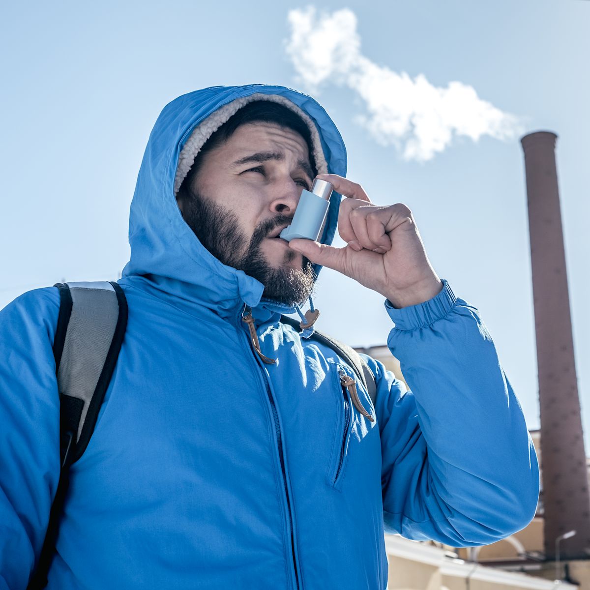 Hiker inhaling his asthma pump