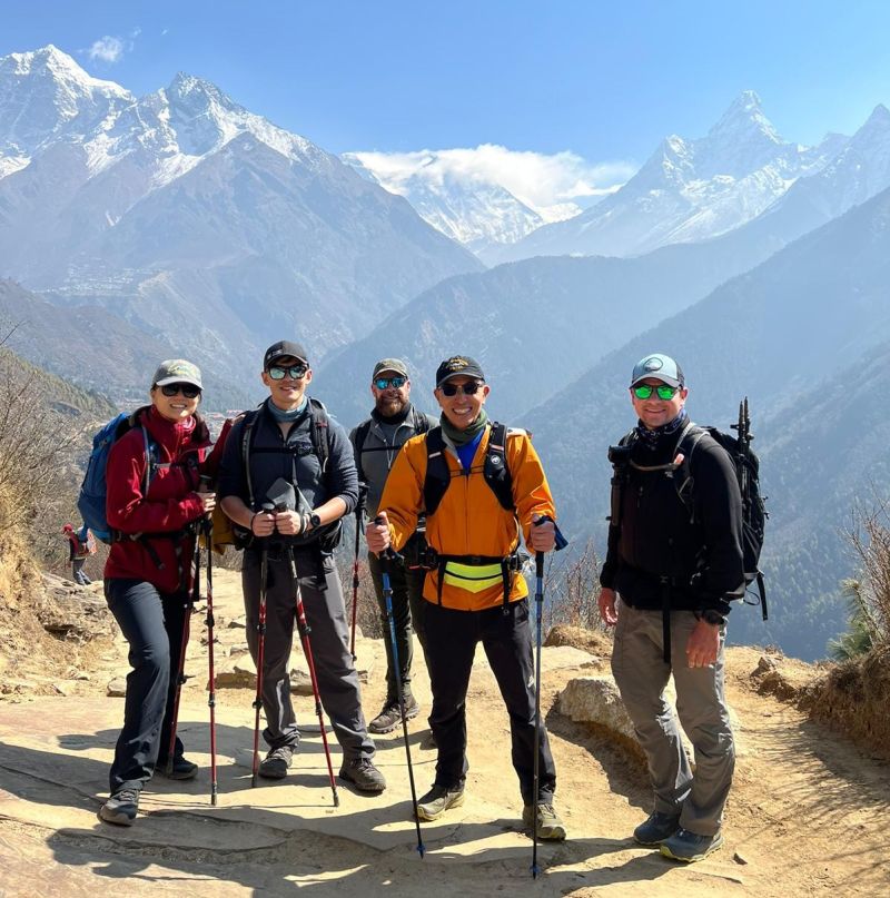 Group pic of trekkers with snowy mountains including Ama Dablam behind them, Everest Base Camp trek, Nepal