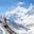 Girl with backpack stands on the edge of the mountain overlooking the snow-capped peaks of the Himalayas on Annapurna Circuit Trek in Nepal. (1)