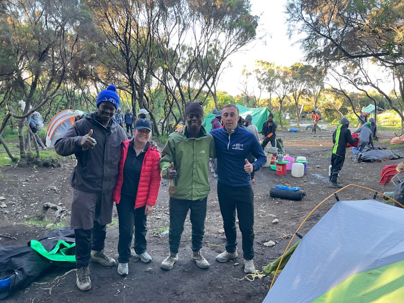 Smiling men and woman at Mweka Camp on Kilimanjaro