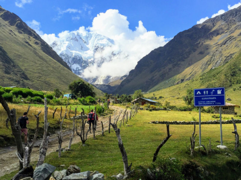 Walking through an open valley along the Salkantay Trail on the way to Macchu Picchu, Peru 