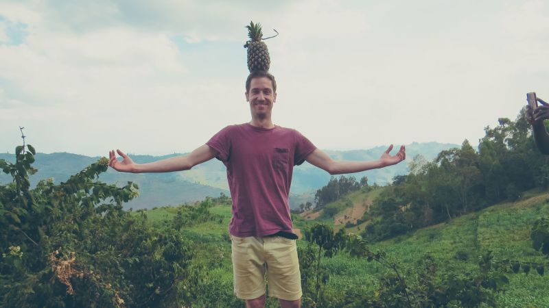 Happy-man-balancing-a-pineapple-in-Uganda.jpg