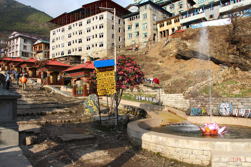 Landscape of central part of Namche Bazaar city with fountain and prayer wheels